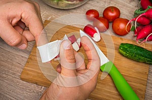 Woman is applying band aid plaster on her finger