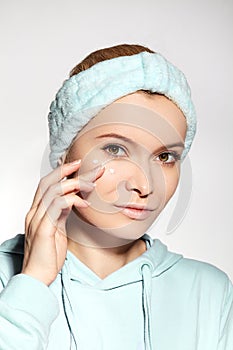 Woman Applying Beauty Skin Cream. Wrinkle Cream or anti-aging Skin Care Moisturizer. Daily Morning Face Care Routine