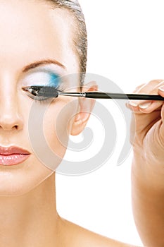 Woman applying blusher eyelid photo