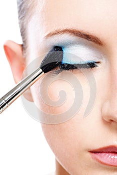 Woman applying blusher eyelid photo