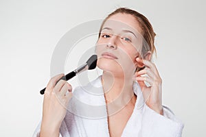 Woman applying blusher