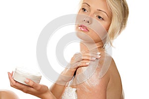 Woman applying body cream photo