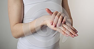 Woman applying body cream on both hands