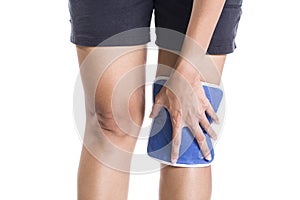Woman applying cold pack on swollen hurting knee