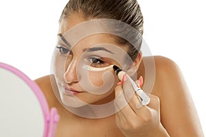 Woman applying concealer