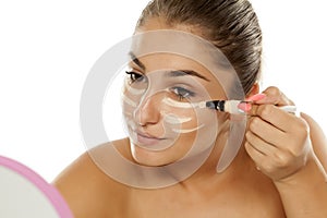 Woman applying concealer