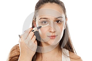 Woman applying concealer