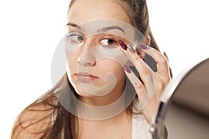 Woman applying concealer