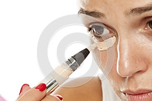 Woman applying concealer