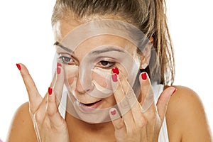 Woman applying concealer