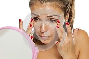 Woman applying concealer