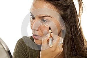 Woman applying concealer