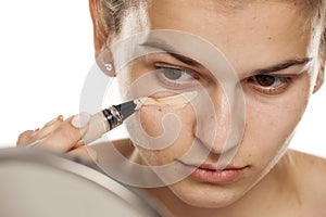 Woman applying concealer