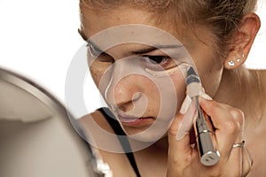 Woman applying concealer