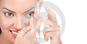 Woman Applying Contact Lens On Her hazel Brown Eyes