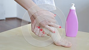 Woman applying cream on foot