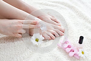 Woman applying cream on her feet