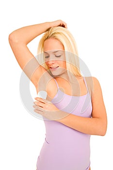 Woman applying deodorant