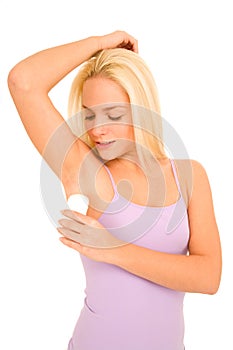 Woman applying deodorant under her armpits