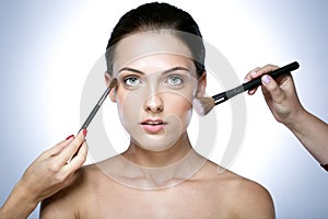 woman applying dry cosmetic tonal