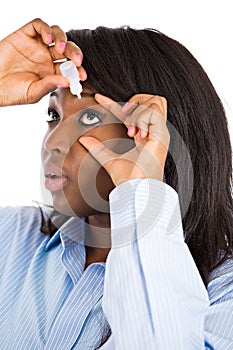 Woman applying eye drops