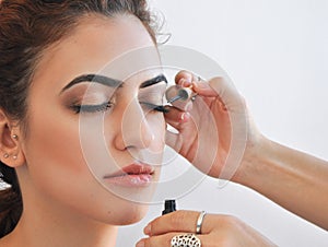 Woman applying eyeliner on her eyes