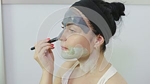 Woman applying a face mask