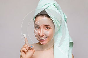 Woman applying a face mask. Face skin care. Skin treatment.