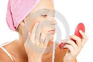 Woman applying facial cream