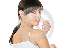 Woman applying facial cream