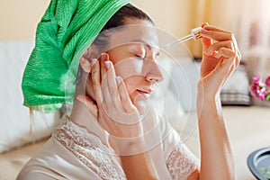 Woman applying facial hyaluronic acid serum. Skincare treatment. Product for oily skin with acne and large pores