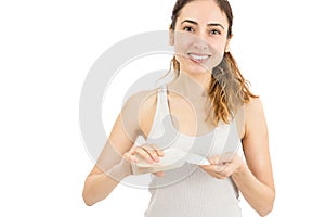 Woman applying facial tonic with a cotton ball