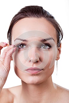 Woman applying fake eyelashes