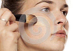 Woman applying foundation