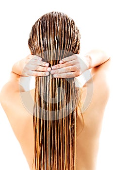 Woman applying hair conditioner. Isolated on white.