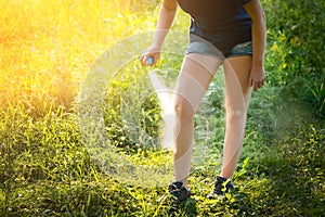 Woman applying insect repellent before forest hike beautiful sum photo