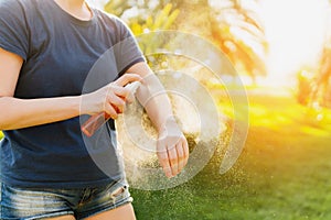 Woman applying insect repellent before forest hike beautiful sum photo