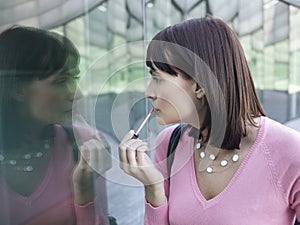 Woman Applying Lip Gloss