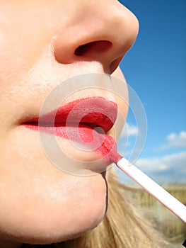 Woman applying lipstick