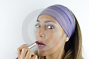 Woman applying lipstick