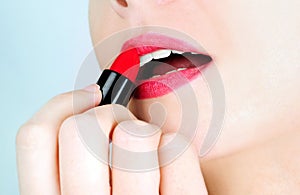 Woman applying lipstick