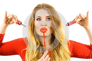 Woman applying lipstick or lip gloss