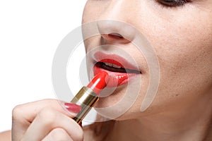 Woman applying lipstick for lips.