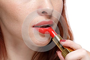 Woman applying lipstick for lips.