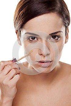 Woman applying liquid base