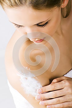 Woman applying lotion