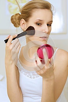 A woman applying make-up