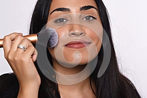 Woman applying make up