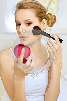 A woman applying make-up