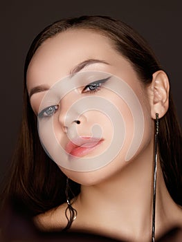 Woman applying make up beauty product putting mascara in ring lighted round makeup mirror at home. Beautiful